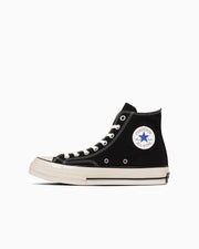 Side view of a black high-top canvas sneaker (All Star LGCY HI) with white rubber sole and circular ankle patch on a white background.