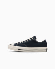 Side profile of a black canvas All Star LGCY OX low-top sneaker on a white background.