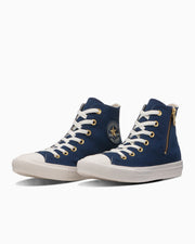 Two navy canvas high-top sneakers with white rubber soles and laces shown from a three-quarter front angle.