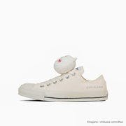 Side view of a canvas low-top sneaker (ALL STAR MC OX) with a small ChiiKawa character figure perched on the heel.