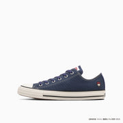 Side view of a navy canvas All Star Ox sneaker on a white background.