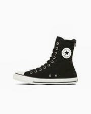 Side-profile photo of a black canvas high-top sneaker with white rubber toe cap, white sole, and round ankle logo.