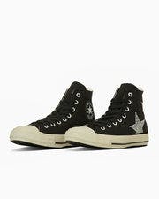 A pair of black high-top All Star canvas sneakers shown from a three-quarter view on a white background.