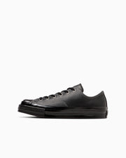 Side view of a black leather low-top sneaker (ALL STAR SQUARETOE LE OX) on a white background.
