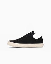 Side view of a black ALL STAR STARSLIP OX canvas sneaker on a white background.