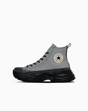 Side view of a high-top leather sneaker (ALL STAR SURGETRAINER CB HI) in grey with a thick black sole and a star logo on the ankle.