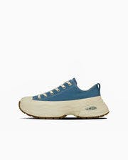 Side view of the ALL STAR SURGETRAINER OX canvas sneaker in blue with a chunky off-white sole.