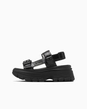 Side profile of a black All Star Trekwave rubber sandal with two buckle straps and a chunky platform sole.