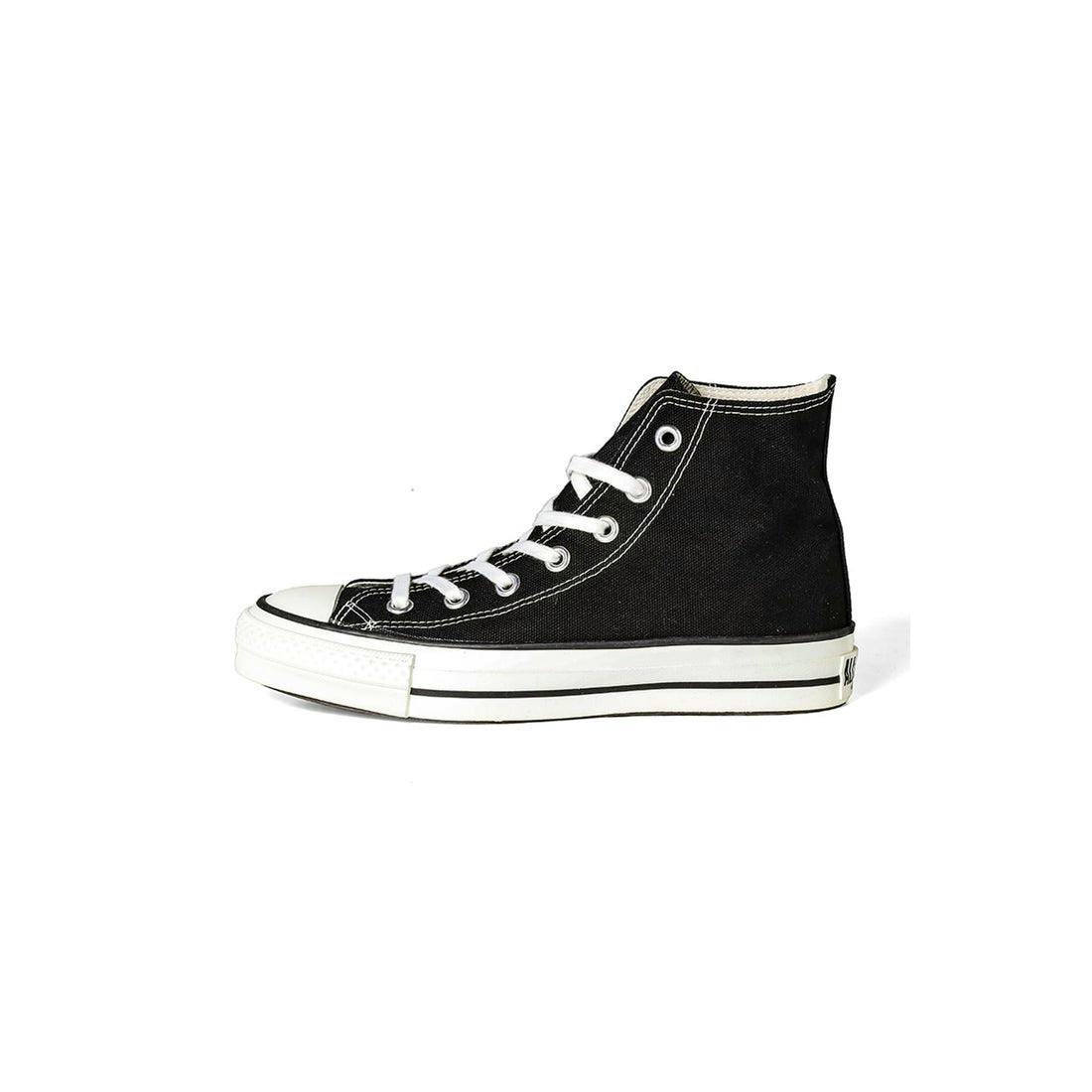 Side view of a black canvas high-top sneaker with white laces and a white rubber sole.