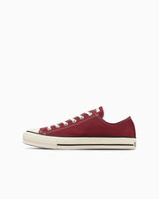 Red canvas low-top sneaker shown in side profile on a white background.