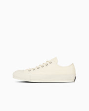 Side profile of a white canvas low-top CHUCK TAYLOR CANVAS OX sneaker.