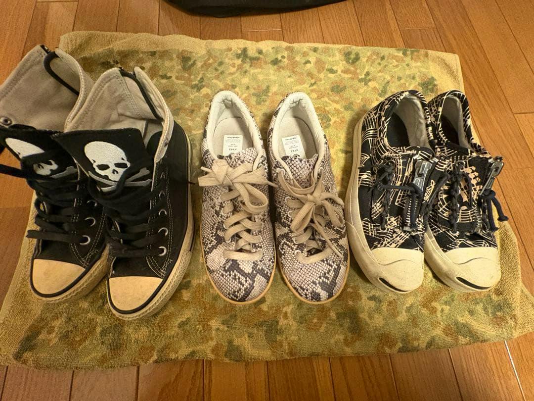Three pairs of CONVERSE canvas sneakers displayed side by side on a towel, shown from the front.