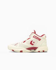 Cream and red CONS Accelerator Mid mid-top sneaker shown at a slight angle on a white background.