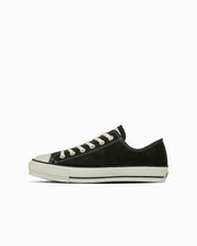 Black suede low-top shoe shown in side view on a white background.
