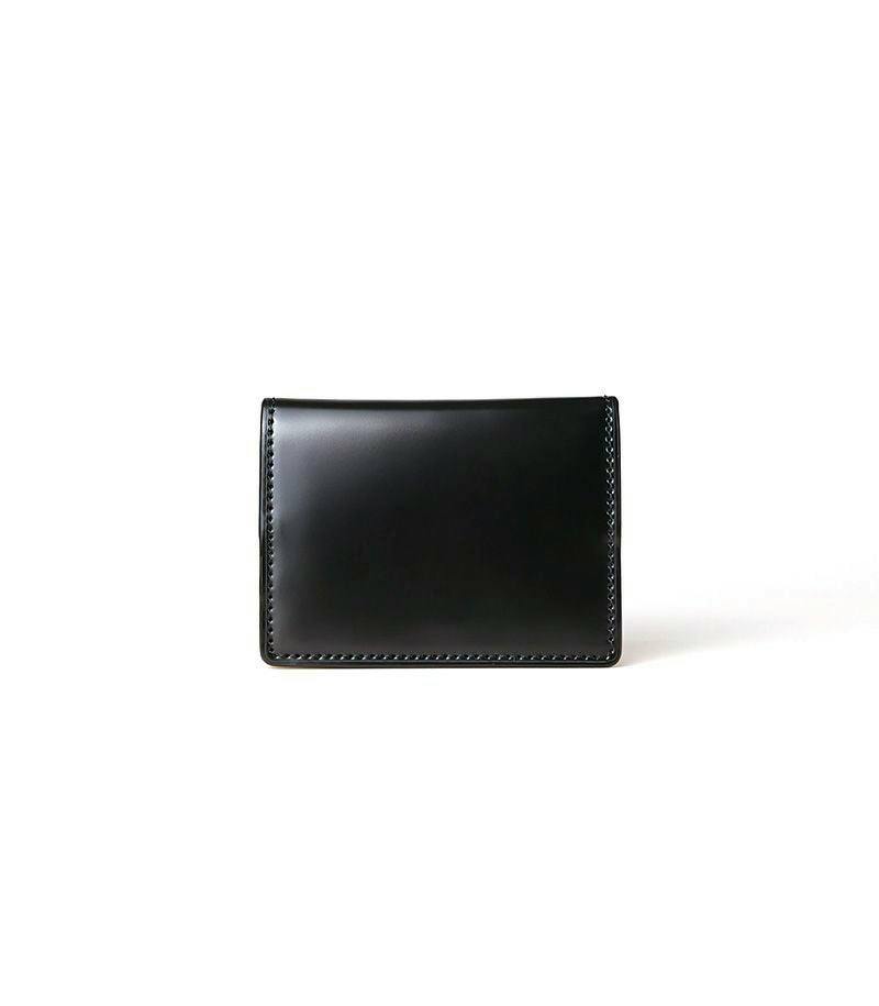 A black cordovan and vegetable-tanned leather box coin wallet shown closed on a white background.