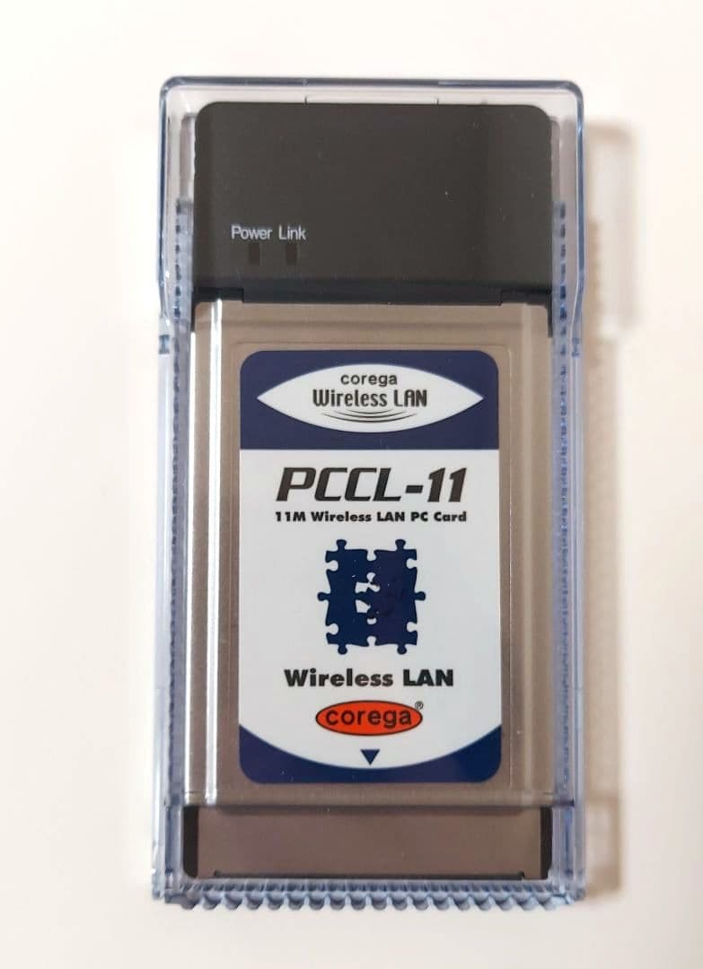 A corega Wireless LAN PCCL-11 PC Card in a clear plastic protective case with its label visible.