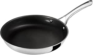 Angled top view of a stainless-steel frying pan with a black nonstick interior and a long metal handle.