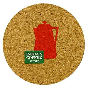 Round cork coaster printed with a red teapot silhouette and a small green "INODA'S COFFEE KYOTO" logo.