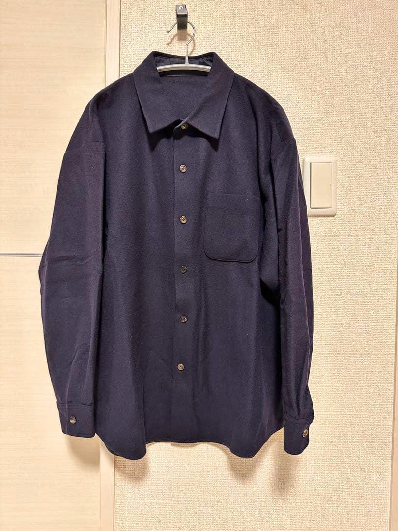 Navy wool long-sleeve button-up shirt (size S) hanging on a hanger showing the front view.