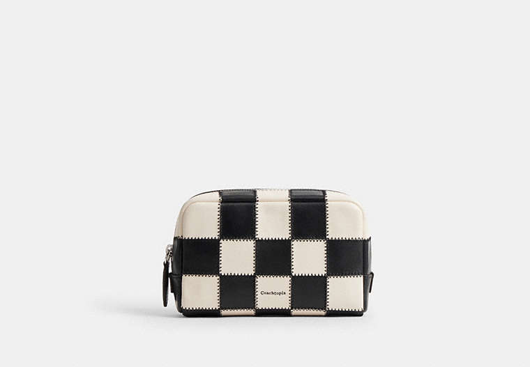 Front view of a black-and-white checkerboard cow leather cosmetic pouch.