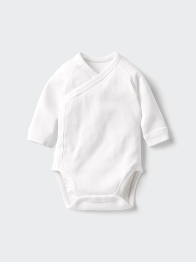 White cotton baby onesie with a front-overlap opening and snap closures, laid flat on a light background.