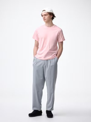 Model wearing a pink cotton crew-neck T-shirt against a plain white background.