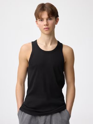 Model wearing a black cotton ribbed tank top, front view.