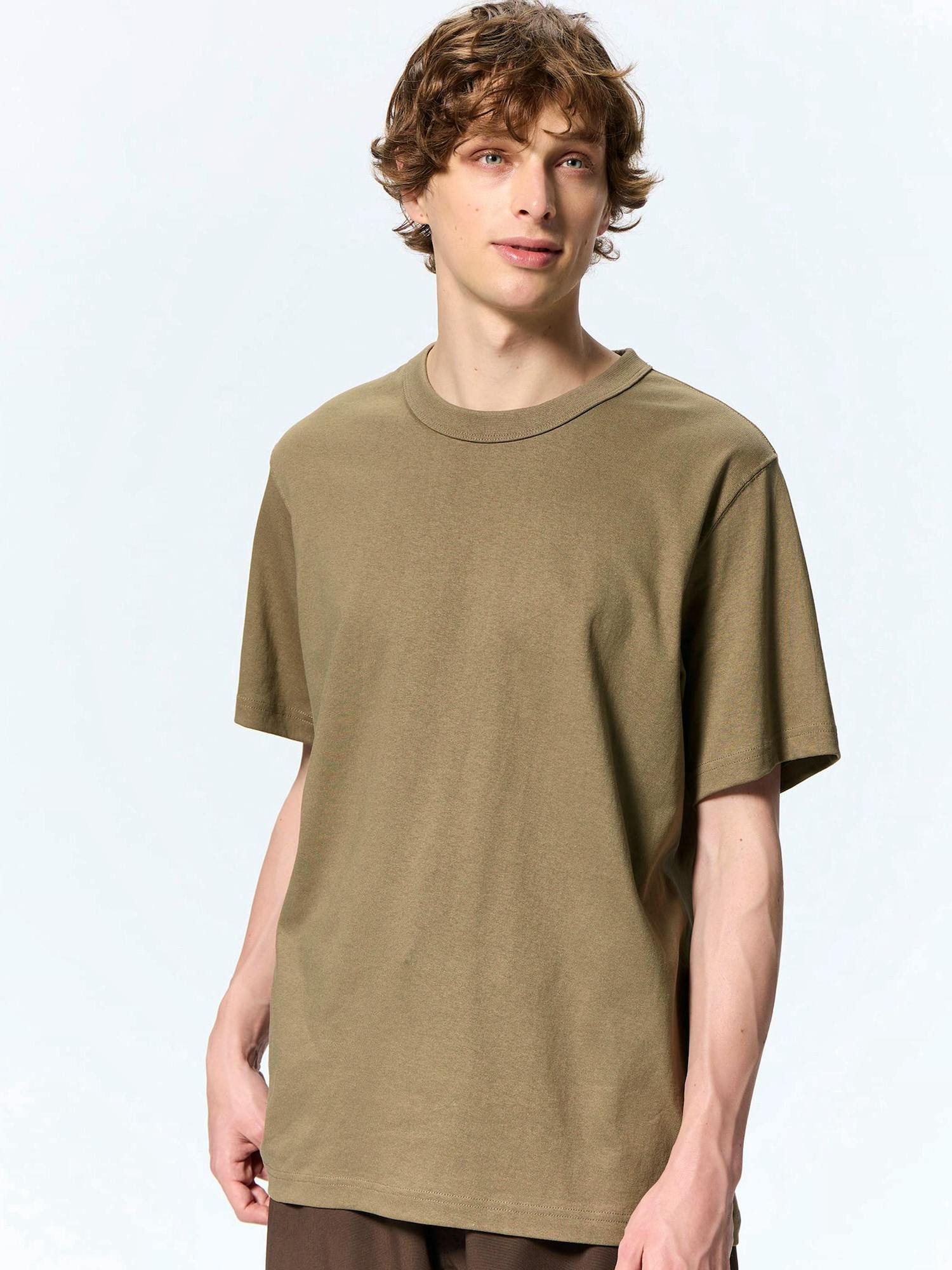 Male model wearing an olive-green cotton crew-neck short-sleeve T-shirt shown from chest upward.