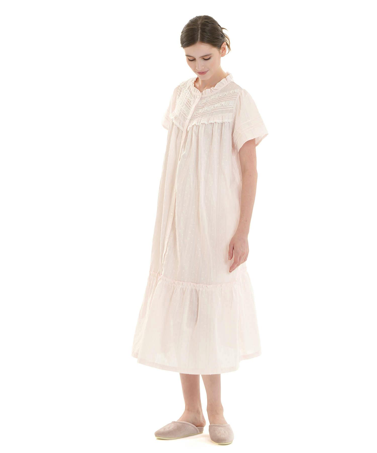A model wearing the cotton frill dress with a ruffled yoke and button-front against a white background.