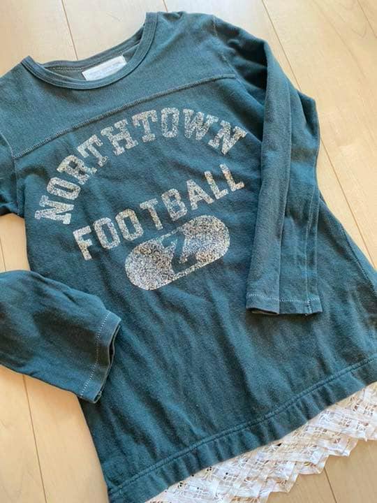 Green cotton long-sleeve T-shirt laid flat showing "NORTHTOWN FOOTBALL" printed on the front.