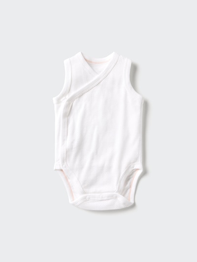 White sleeveless cotton baby bodysuit with a front-opening wrap design laid flat.