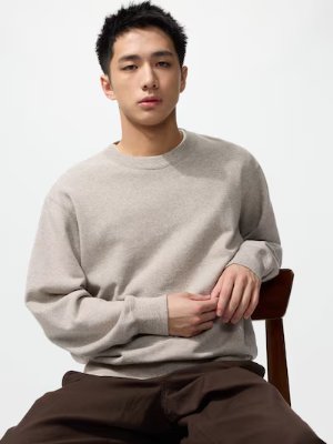 Male model seated wearing the sweatshirt, shown from the front.