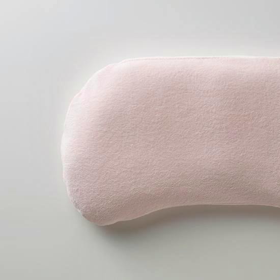 Light pink towel-style pile pillow cover fitted on a curved HIDA pillow.
