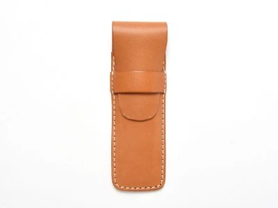 Tan cow leather pencil case with a flap closure shown flat against a white background.