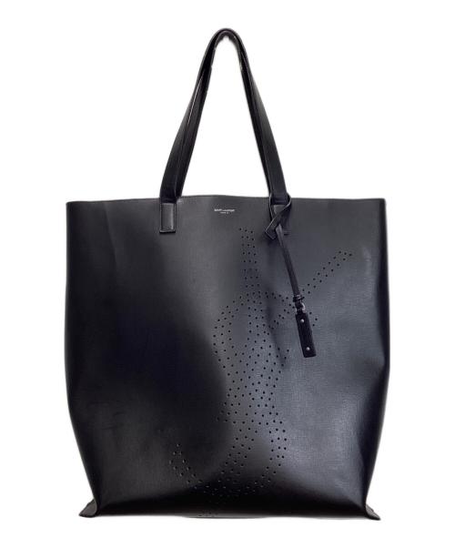 Black cow leather tote bag with two shoulder straps and a perforated decorative pattern on the front.