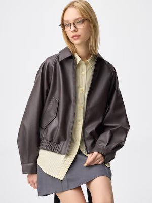Female model wearing the women's polyester dark brown jacket shown from the front.