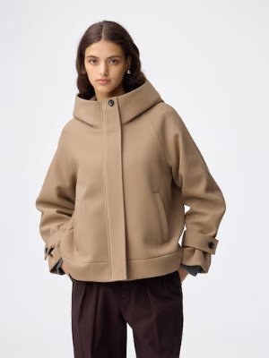 Model wearing the short hooded women's coat shown from the front.