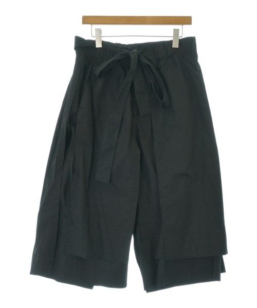 Black men's polyester pants by CRAIG GREEN hanging on a wooden hanger against a white background.