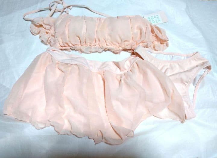 Pink Cretamoon frill women's two-piece swimwear laid flat on a white background.