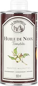 A metal 500 ml can of Croix-Velte walnut oil with a front label reading "Huile de Noix" and an illustration of walnuts.