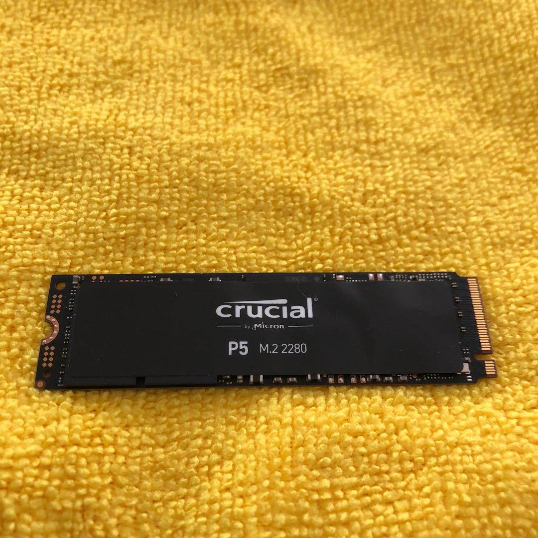 A Crucial P5 M.2 2280 SSD placed on a yellow cloth.