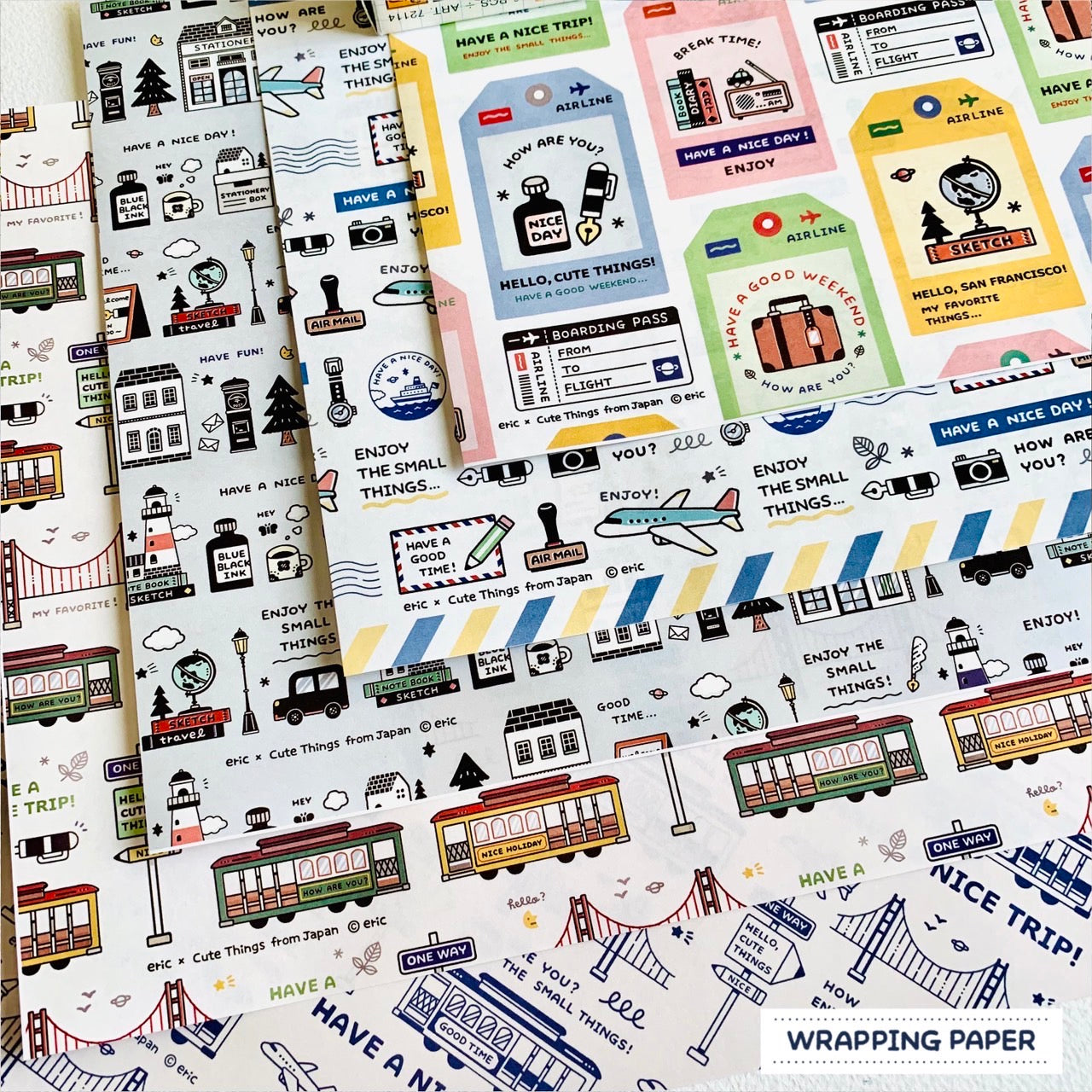 Overlapping sheets of SF Special CTFJ x eric wrapping paper showing travel-themed illustrated designs.
