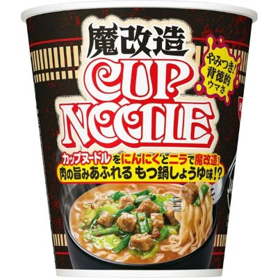Front-facing cup of instant noodles labeled "魔改造 CUP NOODLE" showing the packaging artwork of noodles and toppings.