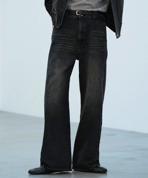 Front view of a model wearing men's curved flare denim slacks in black.