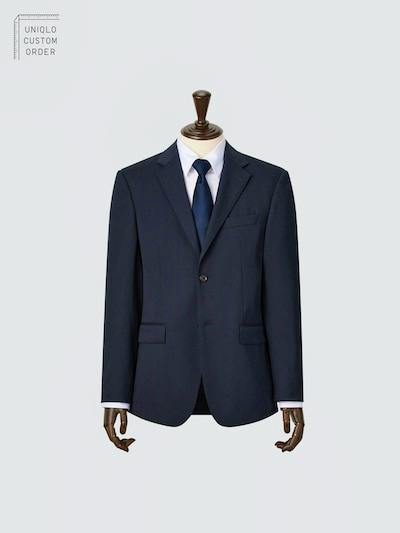 Navy men's wool jacket displayed on a mannequin wearing a white shirt and dark tie.