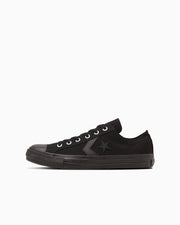 Side view of a black canvas low-top sneaker (CXP OX) on a white background.