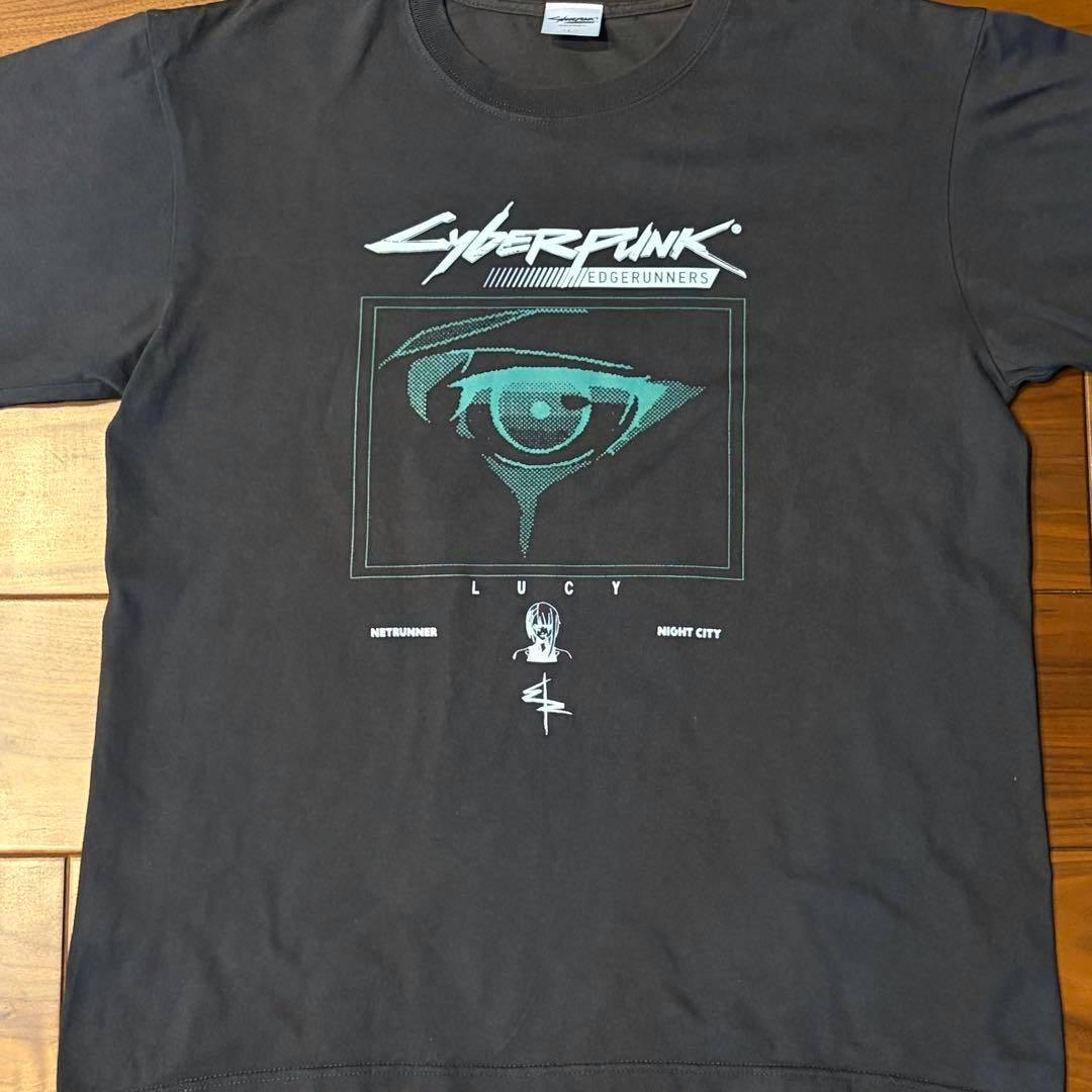 Black Cyberpunk: Edgerunners anime T-shirt laid flat showing the front Lucy eye graphic and logo.