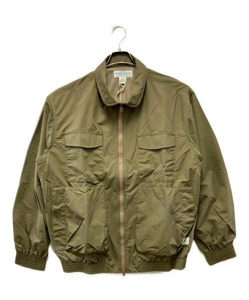 Front view of a men's nylon D/C Armor Jacket Light in olive green hanging on a hanger against a white background.