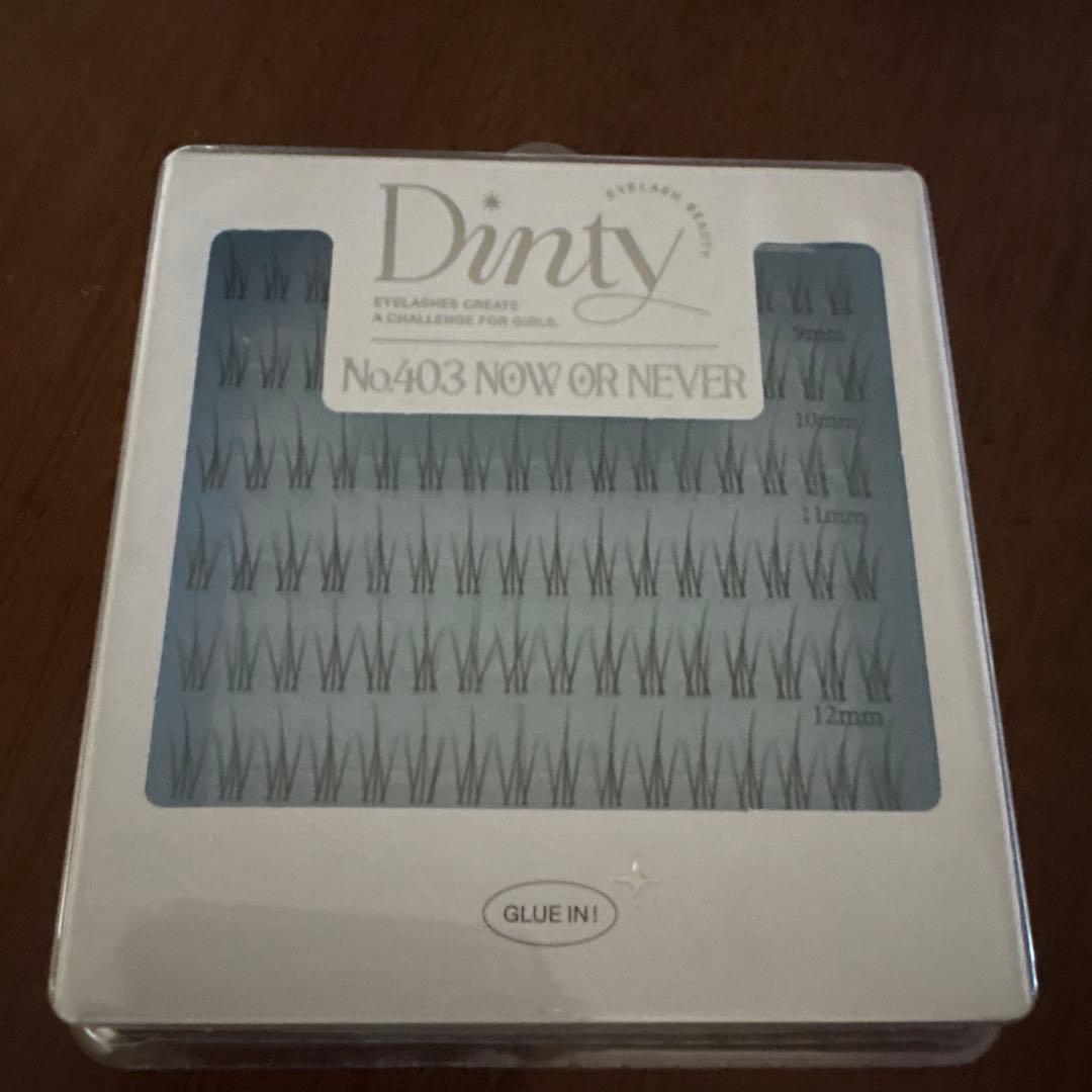 Front view of packaged Dinty false eyelashes No.403 “NOW OR NEVER” showing multiple individual lash clusters through the window.