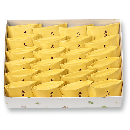 An open box showing twenty-four individually wrapped cakes in yellow packets.